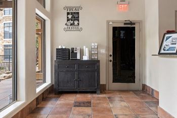 A coffee shop with a black cabinet at Waters Edge Apartment Homes, Georgetown, TX